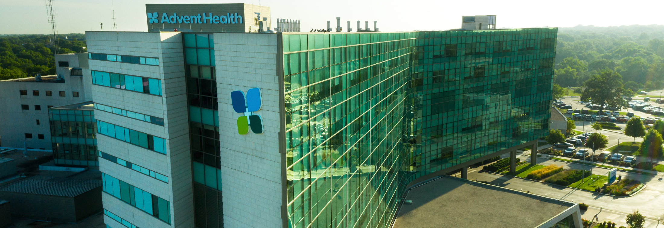 Exceptional Care With Uncommon Compassion Three doctors having a discussion in a hospital hallway.